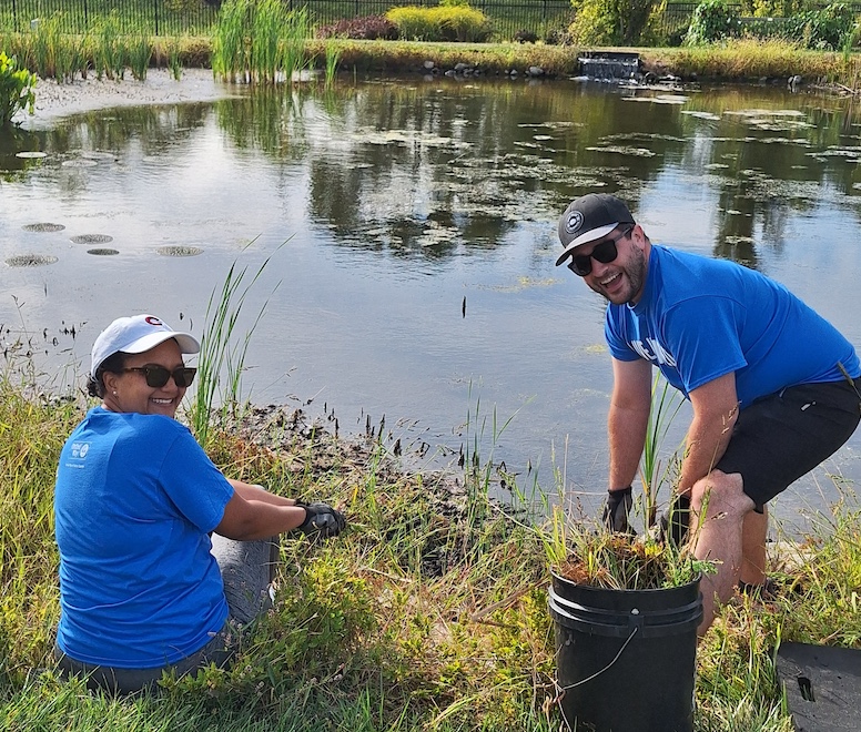 Akelo and Leif pulling weeds at Reiman Gardens