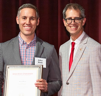 Arthur Winter receiving his university award from Jason Keith